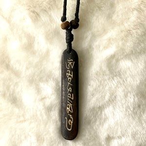 Craved writing on stone pendant